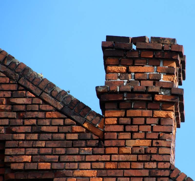 Damaged chimney on an Trabuco Canyon home showing cracks and missing mortar